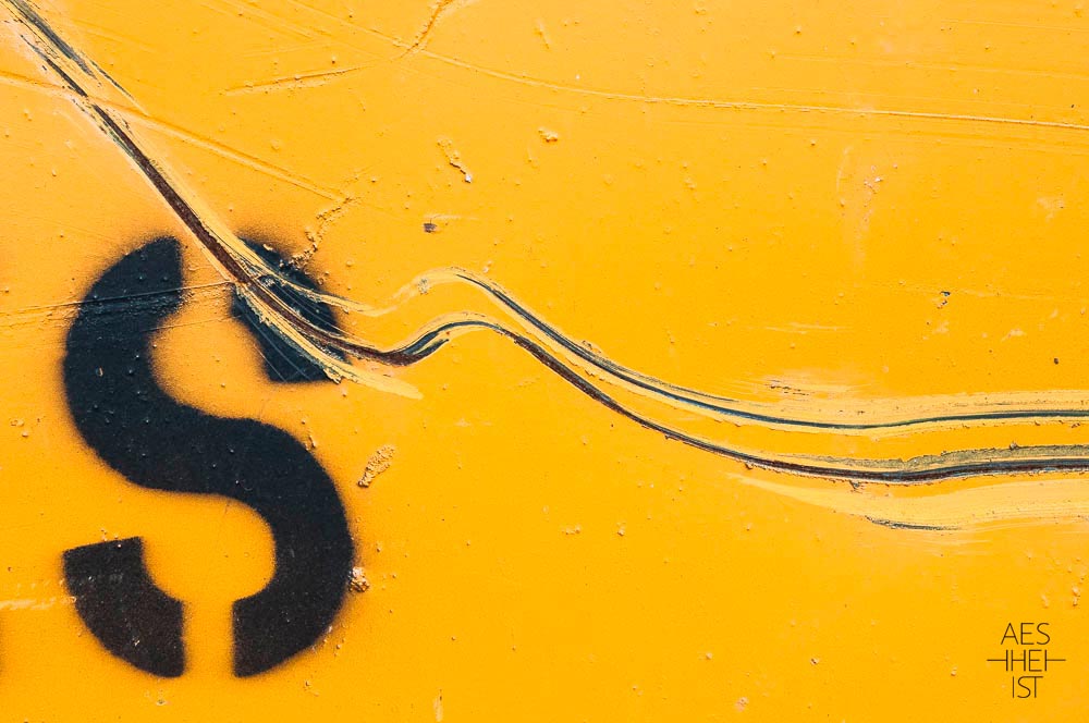 letter S on yellow background with rolling scratches