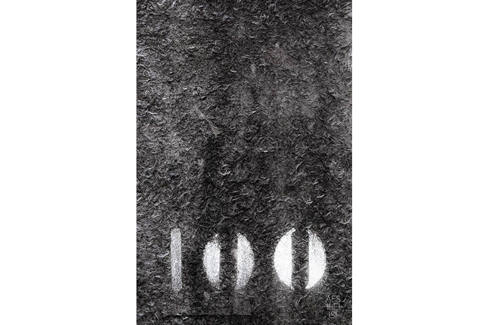 the number 100 sprayed onto gray fibers