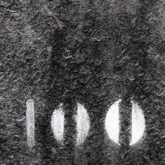 the number 100 sprayed onto gray fibers