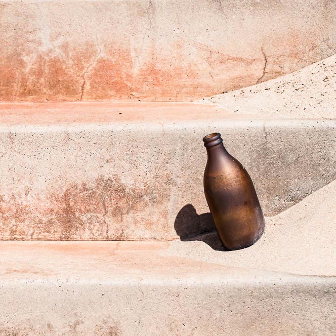 sand blasted bottle on a stair