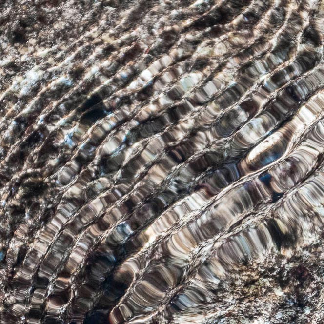 second picture: shafts of sunlight painting pattern into water